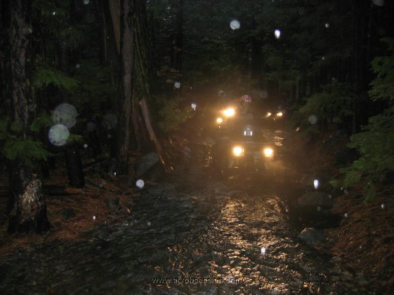 03. My neighbor Dan driving Miren's ATV.  The road is a river.jpg